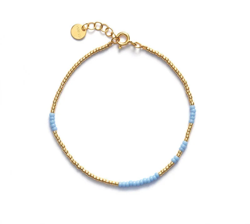 Luxury Jewelry Without The Luxury Price Tag Asym Gold Plated Bracelet w. Light Blue Beads